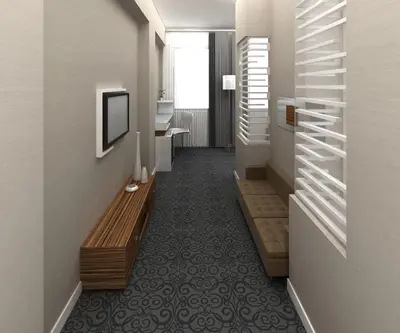 a hallway with a couch and a television on a wall at Hotel Yenibosna in Istanbul