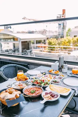 a table with many plates of food on it at RW BOUTIQUE HOTEL in Istanbul