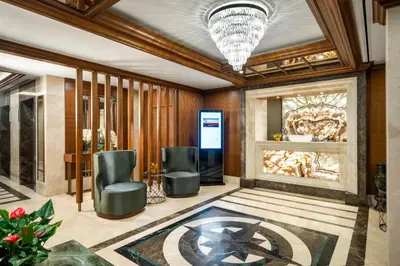 a lobby with two chairs and a painting on the wall at Aspera Hotel Golden Horn in Istanbul