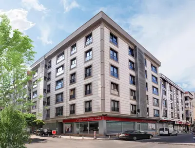 a large white building on the corner of a street at Family Time Suites Hotel in Istanbul