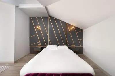 a bedroom with a white bed and a black wall at Family Time Suites Hotel in Istanbul