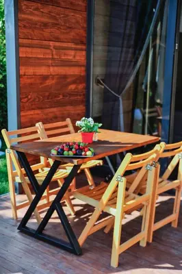 a wooden table with chairs and a bowl of fruit on it at Minimalist Sapanca in Sapanca