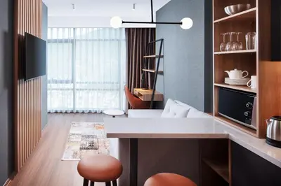 a kitchen with a counter and a table and chairs at Residence Inn by Marriott Istanbul Atasehir in Istanbul