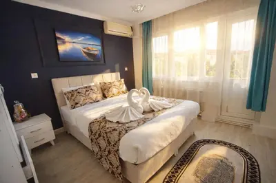 a bedroom with a bed with a swan on it at Alpacino Apart Hotel in Istanbul