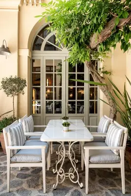 a white table and chairs under a tree at Ecole St. Pierre Hotel in Istanbul