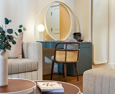 a living room with a chair and a mirror at Ecole St. Pierre Hotel in Istanbul