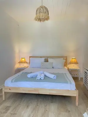 a bed with two rolled up towels on it at Ikigai Hotel Villa Rıfat in Adalar