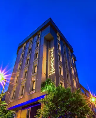 a building with a lit up sign on it at Valente Suites&Hotel in Istanbul