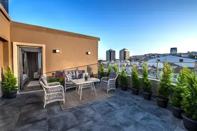 a patio with chairs and a table on a balcony at Valente Suites&Hotel in Istanbul