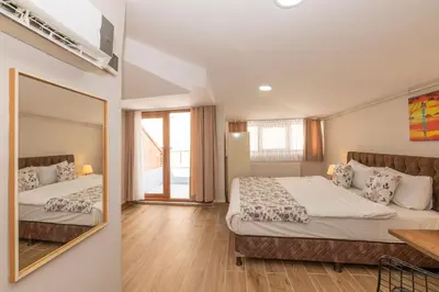 a bedroom with two beds and a mirror at Marida Residence - Istanbul Taksim in Istanbul