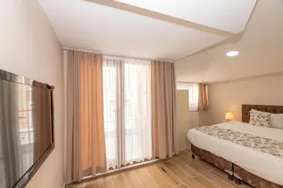 a bedroom with a bed and a large window at Marida Residence - Istanbul Taksim in Istanbul