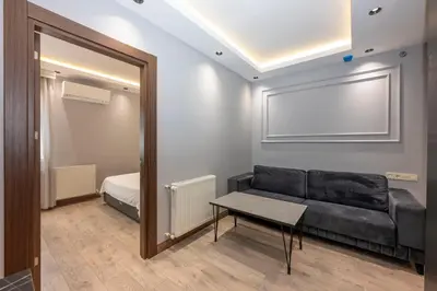 a living room with a couch and a mirror at Comfort Suites Hotel in Istanbul
