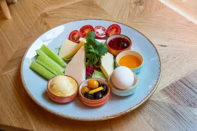 a plate of food with fruits and vegetables and eggs at Dosso Dossi Hotels Yenikapı in Istanbul