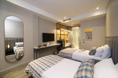 a hotel room with two beds and a mirror at Dosso Dossi Hotels Yenikapı in Istanbul