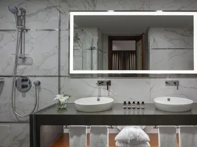a bathroom with two sinks and a mirror at Mövenpick Hotel Istanbul Asia Airport in Istanbul