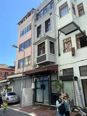 two women walking down a street in front of a building at Blue Mansion Hotel & Flats in Istanbul