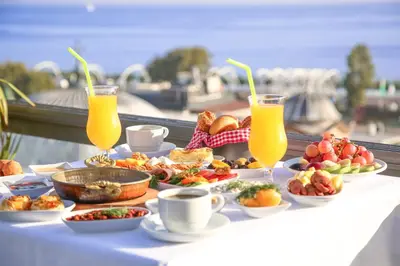 a table with plates of food and two glasses of orange juice at HOTEL BRONTE in Istanbul