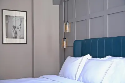 a bedroom with a bed with a blue head board at HOTEL BRONTE in Istanbul