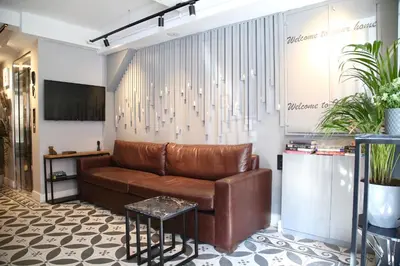 a brown leather couch in a room with plants at HOTEL BRONTE in Istanbul