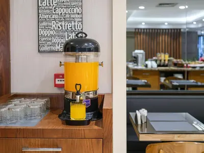 a coffee maker sitting on a counter with a drink at Merlin Hotel İstanbul in Istanbul
