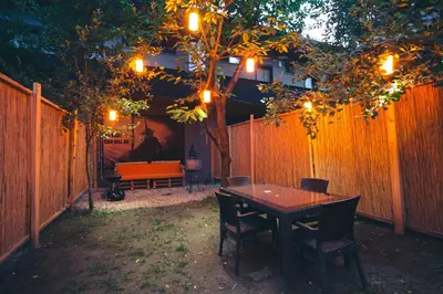 a table and chairs in a backyard with a fence at Bahçeli Concept Sapanca in Sapanca