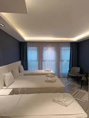 a hotel room with two beds and a table at Sel Suite Hotel in Istanbul