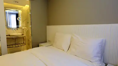 a bedroom with a bed with a sink and a mirror at Sel Suite Hotel in Istanbul