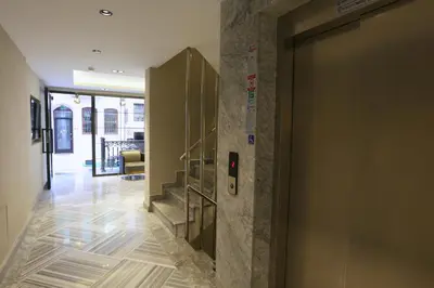 a door in a hallway with a staircase in a building at Sel Suite Hotel in Istanbul
