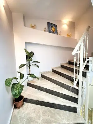 a staircase in a house with potted plants at Cape Palace Hotel in Istanbul