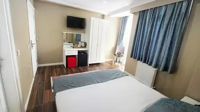 a small room with a bed and a kitchen at Cape Palace Hotel in Istanbul