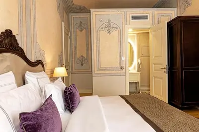 a bedroom with a bed with purple pillows at Meroddi Barnathan Hotel in Istanbul