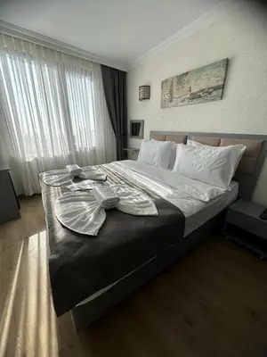 a bedroom with a large bed with a tray on it at Big Orange Hotel Old City in Istanbul