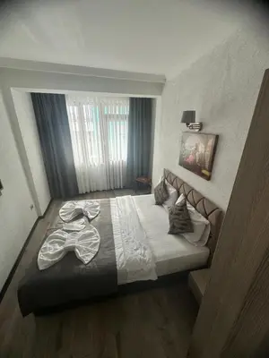 a bedroom with a bed with a pair of glasses on it at Big Orange Hotel Old City in Istanbul