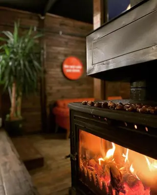 a fireplace with food cooking in it with flames at Villa Siesta Hotel Istanbul Airport in Karaburun