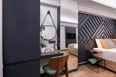 a bedroom with a bed and a desk and a chair at Xenia Hotel Istanbul in Istanbul