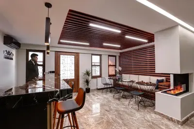 a man standing in a kitchen with a fireplace at Xenia Hotel Istanbul in Istanbul