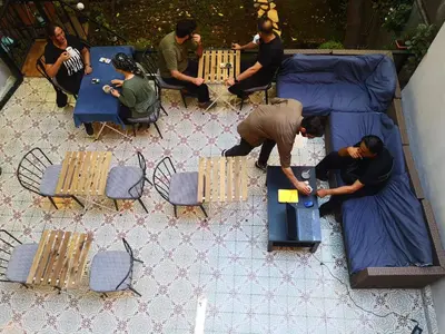 a group of people playing a video game at a table at Gafa Garden Hostel & Apartments - Great Location in Istanbul