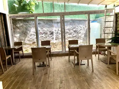 a dining room with tables and chairs and a large window at White Island Boutique Otel in Adalar