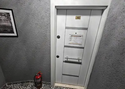 a white door with a mirror in a room at Grey House Apartments & Suites Istanbul in Istanbul