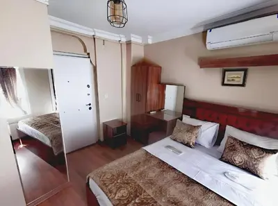 a bedroom with a large bed and a mirror at Grey House Apartments & Suites Istanbul in Istanbul