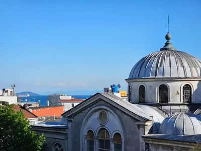 a building with two domes on top of it at Grey House Apartments & Suites Istanbul in Istanbul