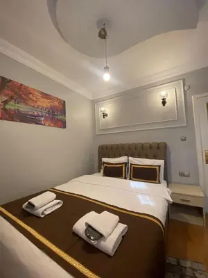 a bedroom with a bed with towels on it at RAMO’S Aparatments & Suites in Istanbul
