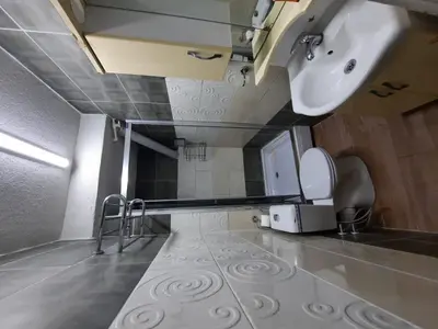 a bathroom with a sink and a toilet and a mirror at RAMO’S Aparatments & Suites in Istanbul