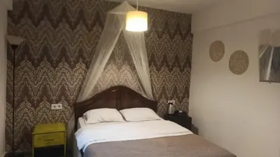 a bedroom with a bed with a canopy at Gölyaka Hotel in Bursa