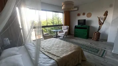 a bedroom with a bed and a large window at Gölyaka Hotel in Bursa