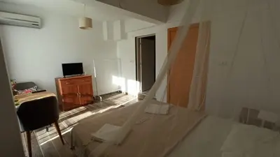 a bedroom with a bed and a desk and a television at Gölyaka Hotel in Bursa