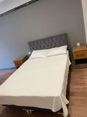 a bedroom with a large white bed with two tables at Almin Apart Hotel in Istanbul