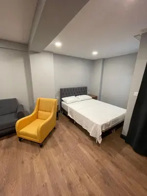 a bedroom with a bed and a yellow chair at Almin Apart Hotel in Istanbul