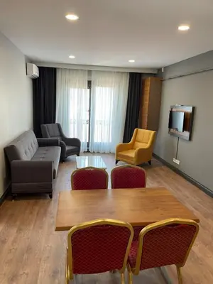 a living room with a couch and a table and chairs at Almin Apart Hotel in Istanbul