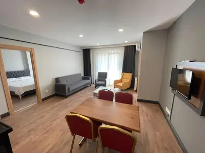 a living room with a table and chairs and a couch at Almin Apart Hotel in Istanbul